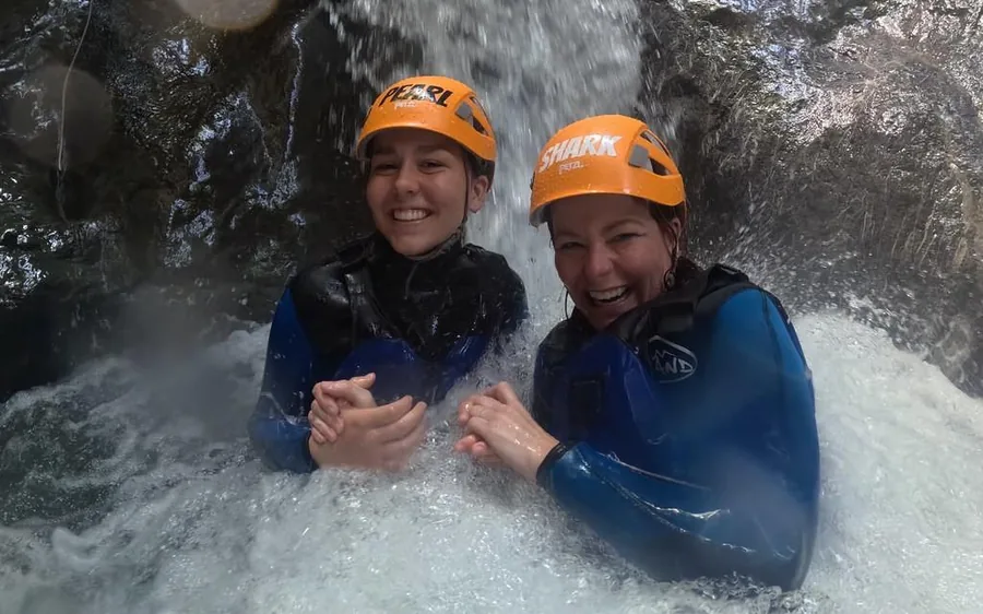 A canyoning group abseiling through a narrow gorge near Interlaken